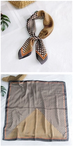 Detail of silk-like square scarf featuring geometric patterns in brown and orange tones