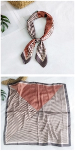 Detail of silk square scarf featuring geometric chain patterns and gray wide borders