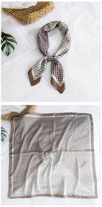 Detail of silk square scarf featuring geometric beige brown patterns and blue polka dots