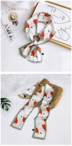 Detailed view of floral silk scarf tied as a ribbon with tulip prints and polka dots