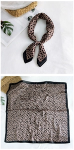 Detailed view of animal print silk scarf with classic leopard pattern and smooth texture