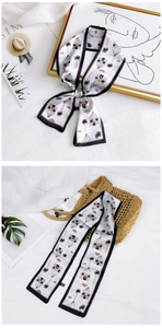 Floral print narrow silk scarf detail with black contrast border and artistic drawings
