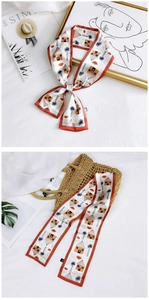 Detail of floral twilly scarf with hand-painted houses and palm trees pattern
