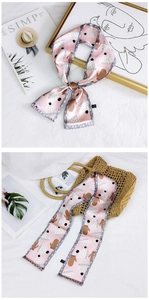 Detail of pink floral narrow scarf showing 100% polyester wash label and print quality