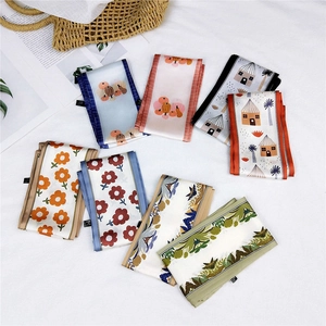 Various floral and botanical printed long silk scarves displayed on a white background