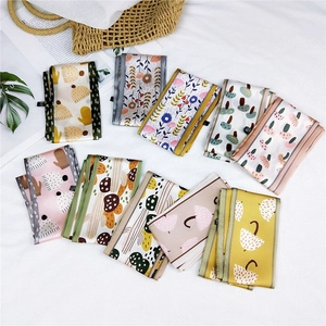 Floral print long silk scarf set with diverse illustrations on a clean white background