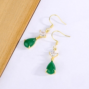 Macro detail of teardrop green chalcedony earrings with gold hooks and square zircon accents