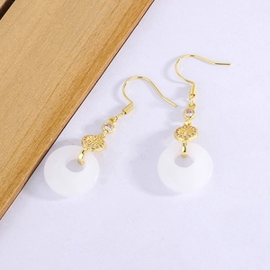 Detail of gold ear hooks with white chalcedony safety buckle and Fu character tassel