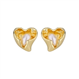 Detailed close-up of 14k gold plated heart earrings with hammered texture and pearls