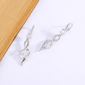 Detail of silver drop earrings with twisted ribbon design and clear zircon stones