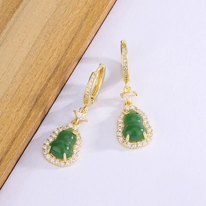 Detail of green chalcedony gourd earrings with sparkling zircon inlay and gold finish