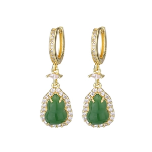 Macro detail of S925 gilded silver earrings with emerald green gourd and zircon stones