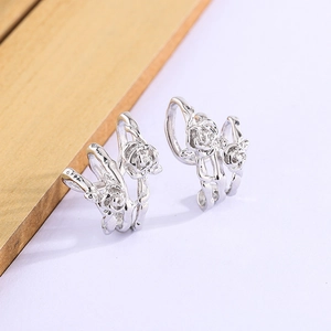 Detailed macro view of vintage silver thorn rose ear clips with intricate 3D floral petals