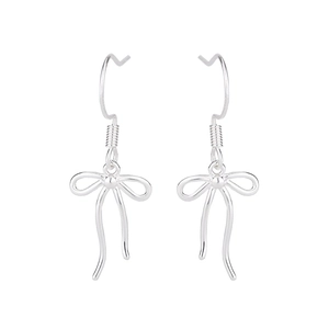 Detail of silver bow tassel earrings featuring minimalist fishhook and sleek metal lines