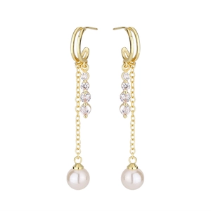 Macro detail of gold tassel earrings featuring sparkling zircons and round white pearls