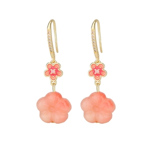 Detail of pink gradient peach blossom earrings with gold metal hooks and zircon accents