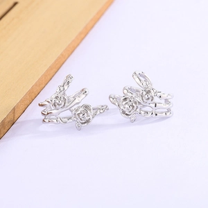 Silver thorn rose ear cuff with 3D floral design on a minimalist white background