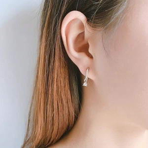Elegant silver leverback earrings with round zircon pendants on female model