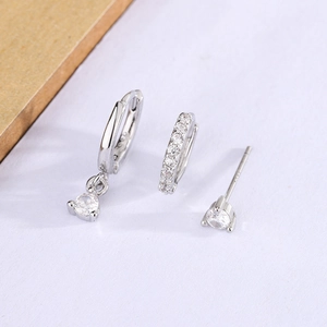 Three-piece geometric silver zircon earring set featuring hoop, mini huggie, and stud