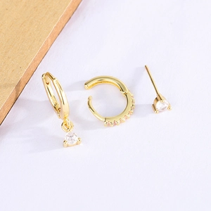 Three-piece gold geometric earring set with teardrop pendant and pink crystals