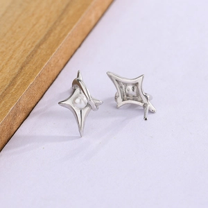 Detailed view of S925 silver star earrings with pearl center on purple background