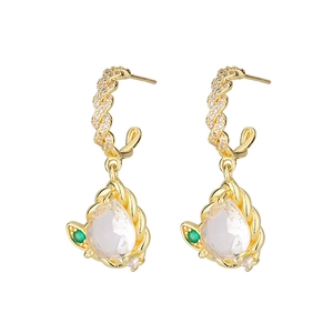 Detailed view of vintage gold twisted earrings with teardrop zircon and emerald accents