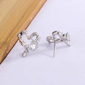 Detailed macro view of S925 sterling silver hollow heart earrings with cubic zirconia