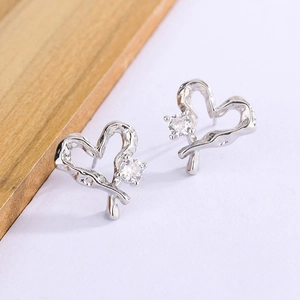 Irregular hollow heart stud earrings with silver lava texture and sparkling cubic zirconia