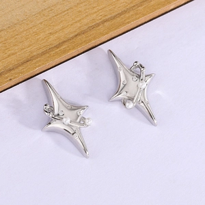 Macro view of silver star stud earrings with white pearls and sparkling cubic zirconia