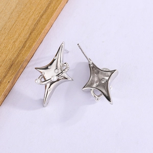 Detailed macro view of minimalist silver star earrings with pearls and cubic zirconia