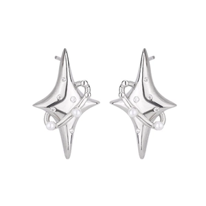 Macro detail of silver starburst earrings featuring delicate pearls and zircon stones