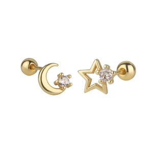 Detailed close-up of asymmetrical gold star and moon stud earrings with zircon inlay