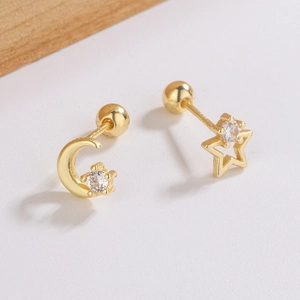 Minimalist asymmetric gold star and moon stud earrings with sparkling cubic zirconia crystals