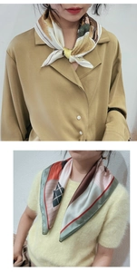 Close-up of stylish silk square scarves with artistic prints and geometric patterns
