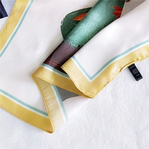 Close-up of floral silk scarf with colorful digital prints and double-stitched edges