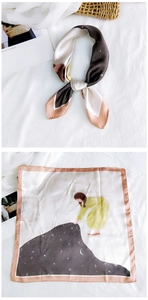 Detail of square silk scarf with fairy tale illustration and satin finish texture