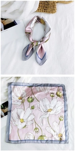 Detail of pink floral silk scarf showing both knotted styling and flat digital flower print