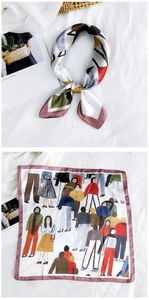 Close-up of square silk scarf featuring a cartoon character print and dusty pink edges