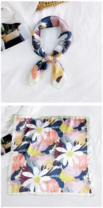 Detail of silk square scarf with daisy print and artistic abstract color blocks