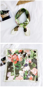 Detailed view of floral silk square scarf with botanical print and elegant tied knot style