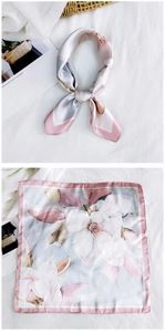Detailed view of floral silk square scarf with pink magnolia print and hand-rolled edges