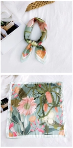 Detail of silk square scarf with light green floral prints and tropical protea flowers