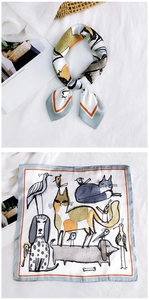 Macro detail of silk square scarf featuring hand-drawn animal illustrations and colorful border