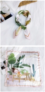 Detail view of a square silk scarf featuring a girl in a botanical illustration pattern