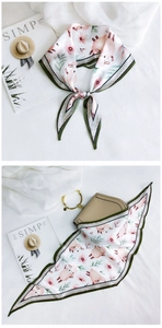 Detail of printed silk scarf tied on handbag and neck with sheep and floral patterns