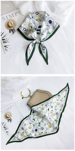 Detail of floral silk scarf with daisy patterns tied on a neck and a handbag handle