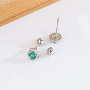 Detail of silver hexagonal emerald zircon studs with screw back for secure wear