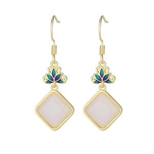 Detailed shot of lotus enamel earrings with Hetian jade pendants and gold hooks