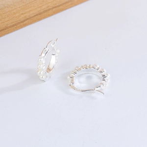 Elegant S925 sterling silver hoop earrings featuring hanging white pearls on a minimalist base