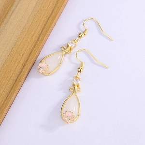Detail of Pipa-shaped silver earrings with white jade inlay and pink enamel petals
